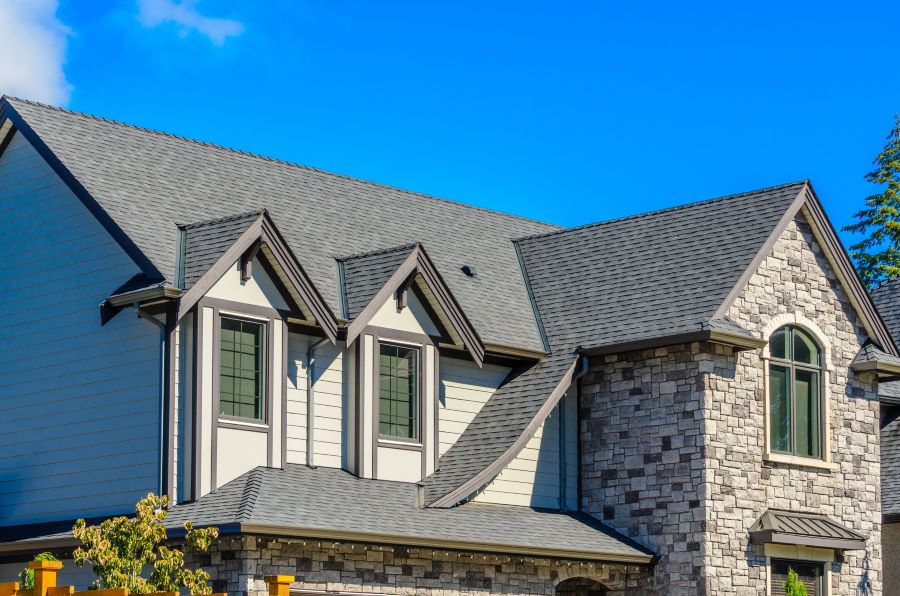 Modern Home with Stone and Siding, Clear Blue Sky, Roof Replacement